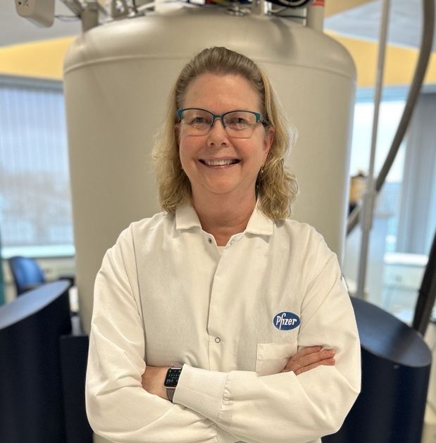 Female scientist in front of NMR magnet