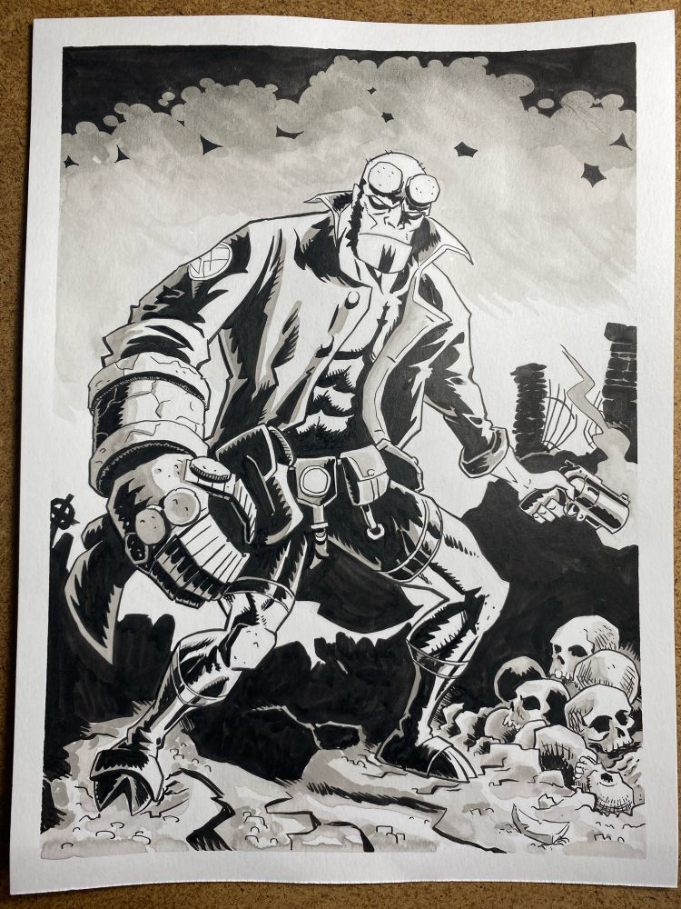 A large demi-demon stands amongst skulls and dirt in what could be a graveyard, while carrying a smoking gun in his left hand. His right hand is oversized and has a rock-like texture, and his demon horns are sanded down to two flat discs above his eyes. He wears a trench coat and combat belt. The image is rendered in heavy black ink and a wash of greys. Hellboy is a no-nonsense paranormal investigator created by American cartoonist Mike Mignola. 