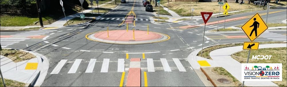 intersection with crosswalks and crosswalk signs and mcdot logo and vision zero logo