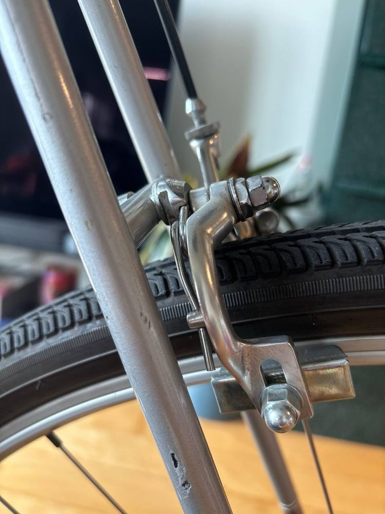 Rear brake caliper on a Schwinn voyageur II. The hardware is offset to actually be closer to the tire, making a fender a tighter fit
