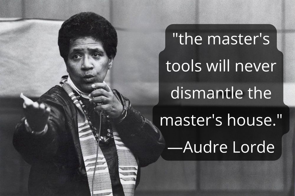 Photo of Audre Lorde, a Black woman with short hair, giving a lecture in a Berlin classroom in 1984. Quote text reads the master's tools will never dismantle the master's house. 