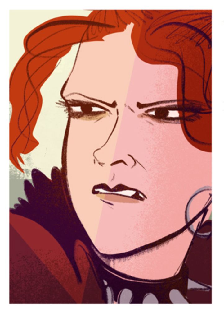 A young red headed woman looks a little angry. 