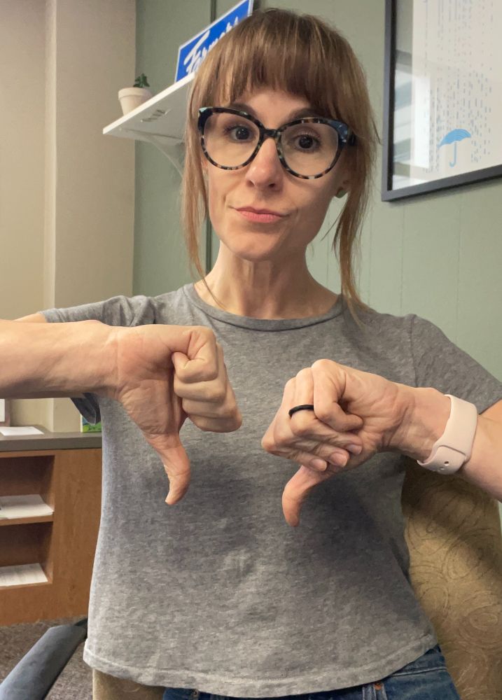 Woman with two thumbs down