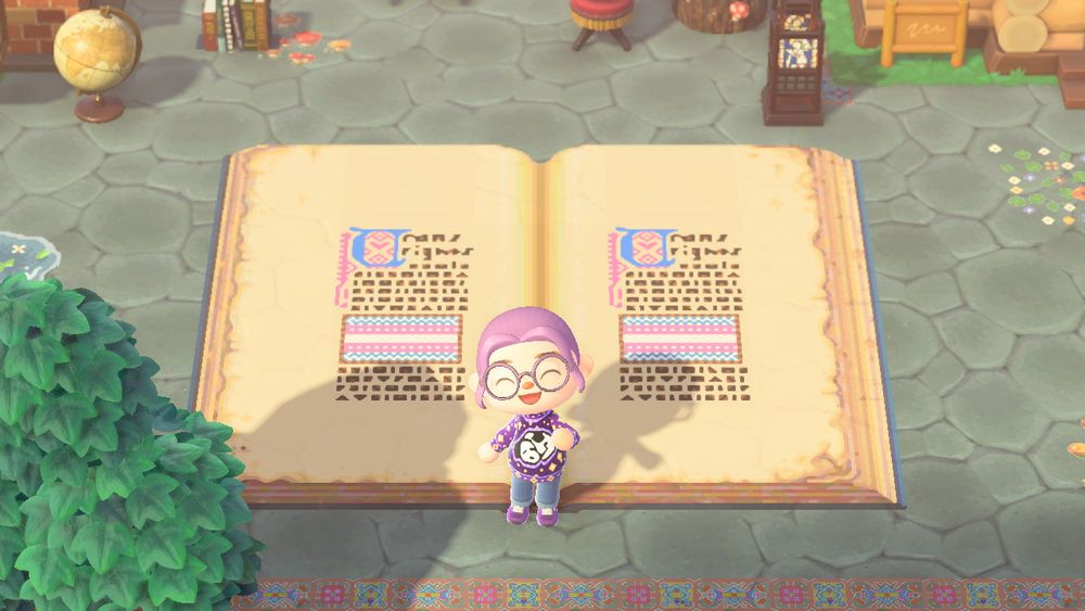 An animal crossing villager with a purple ponytail, round purple glasses, and a purple snoopy custom design sweater, waving as they stand in front of a large medieval manuscript design. The text block in the center of both folios has text with a pink and blue capital T reading "Trans rights" with smaller illegible text and a decorated trans flag below it
