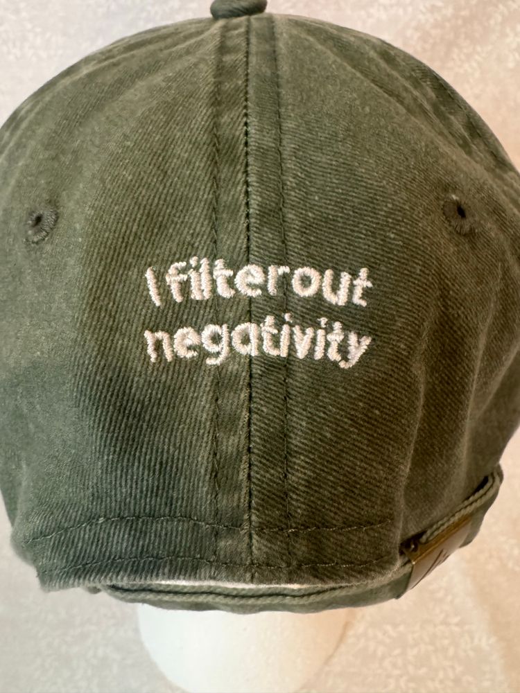 The back of an Olivia baseball cap with the words “I filter out negativity”