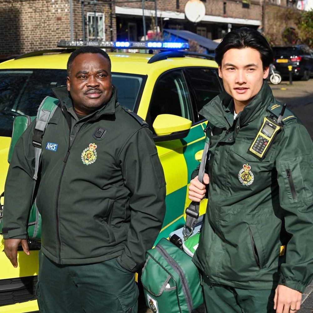 Owusu and Jack carrying clinical equipment.