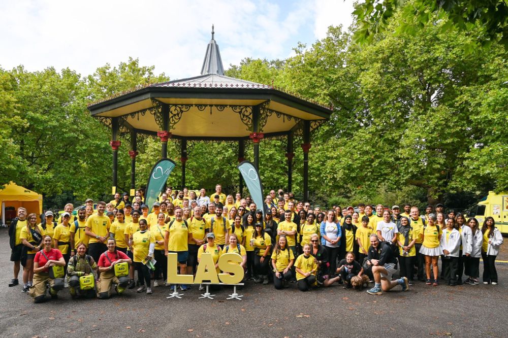 A group photo of all the London Life Hikers at the Battersea Park Bandstand, before their 20km walk to raise money for defibrillators.