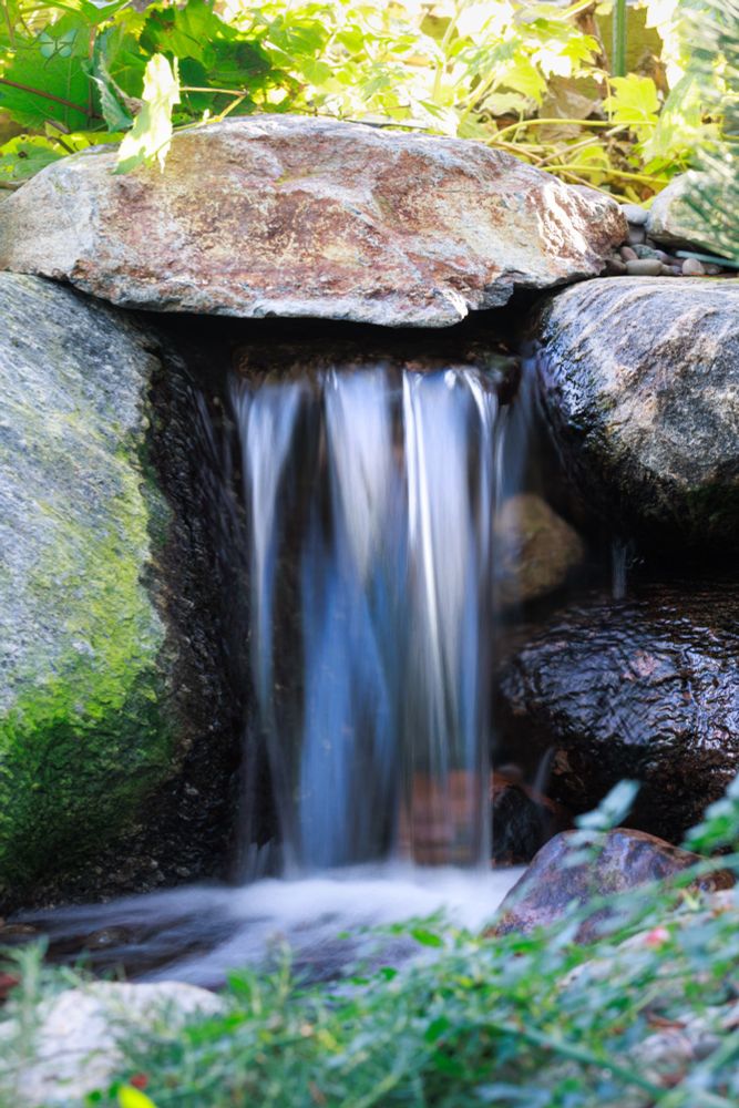 Close up of a small waterfall surrounded by rocks