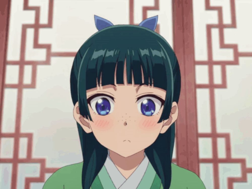 a girl with a blue bow in her hair is wearing a green kimono