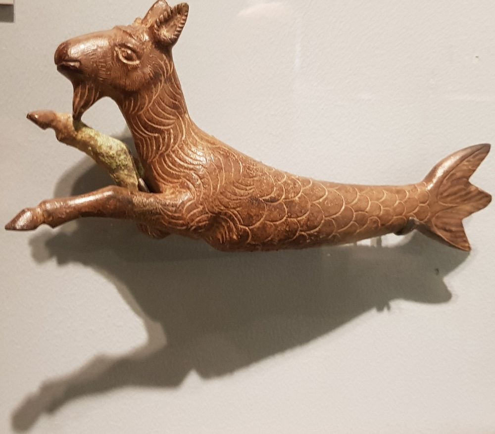Bronze figurine of a Capricorn with head and front legs of a goat and tail of a fish 