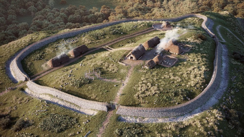 Reconstruction of a Neolithic enclosure from the air showing the ditch, stone walls and internal buildings with smoke rising