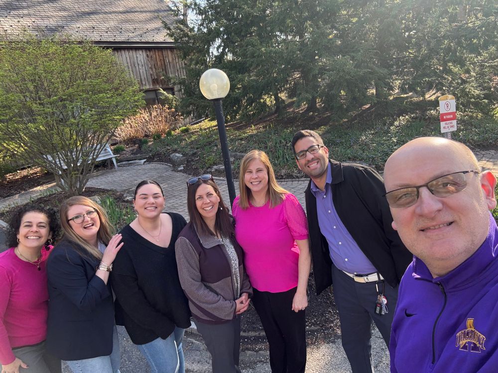 UAlbany Alumni Association staff standing outside at the Alumni House.