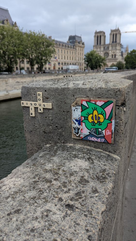 Scrabble pieces and stickers in the gorgeous, Notre Dame in the distance