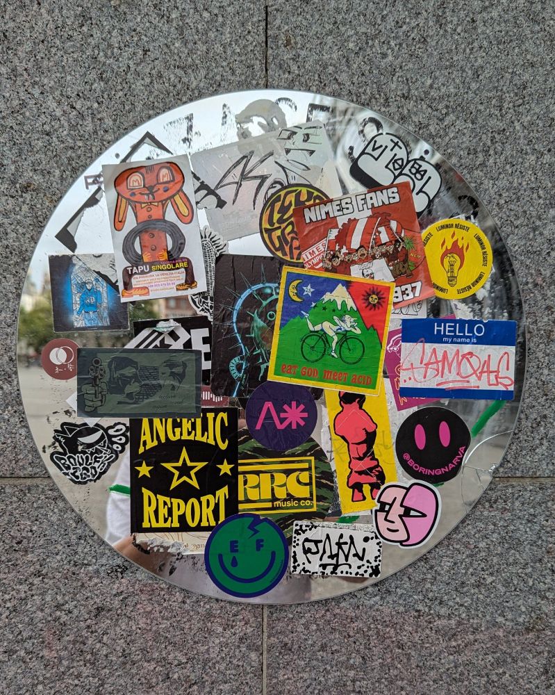 A mirror covered in slaps, stickers