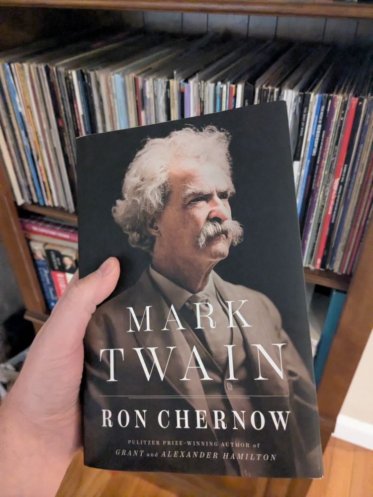 Holding the new biography MARK TWAIN by Ron Chernow