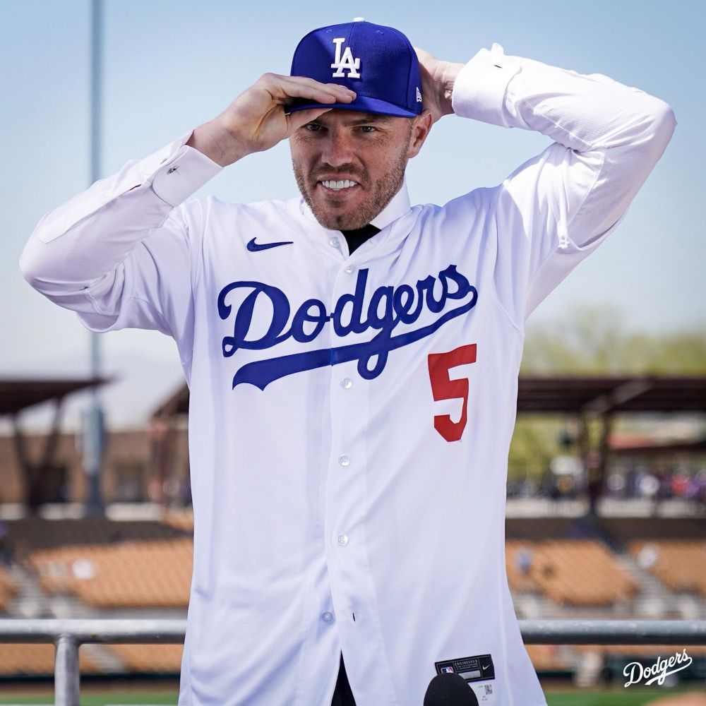 Freddie Freeman in a classic Dodgers jersey where the button split goes through the cursive tie between the O and D