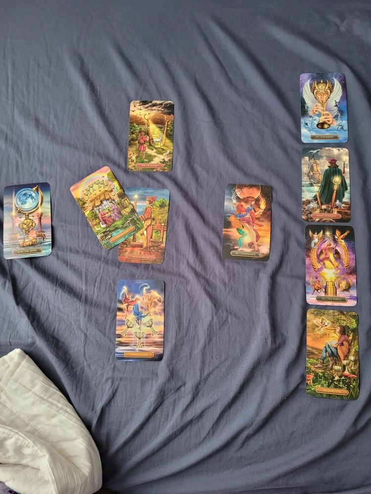 Gilded Tarot cards in a Celtic Cross layout, featuring four major arcana cards. Including Judgment in the outcome position 