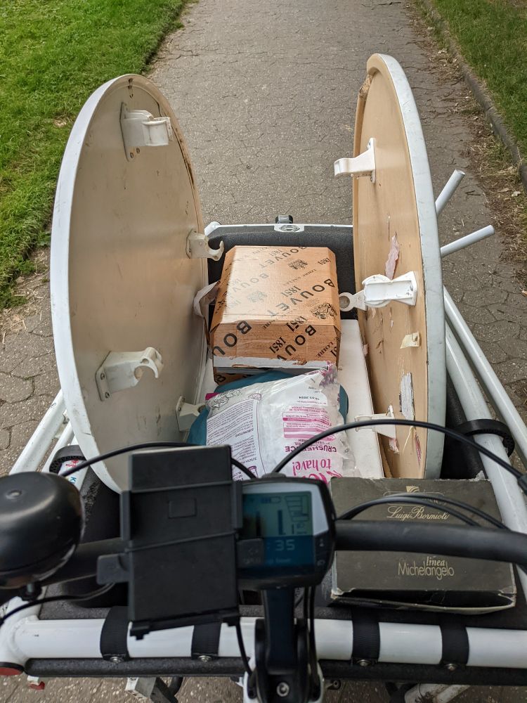 A Cargo Bike loaded with Drinks and Tables.