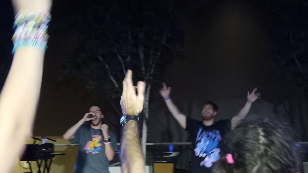 Musicians SpinScissor and Trey Husk performing live onstage at TrotCon 2025