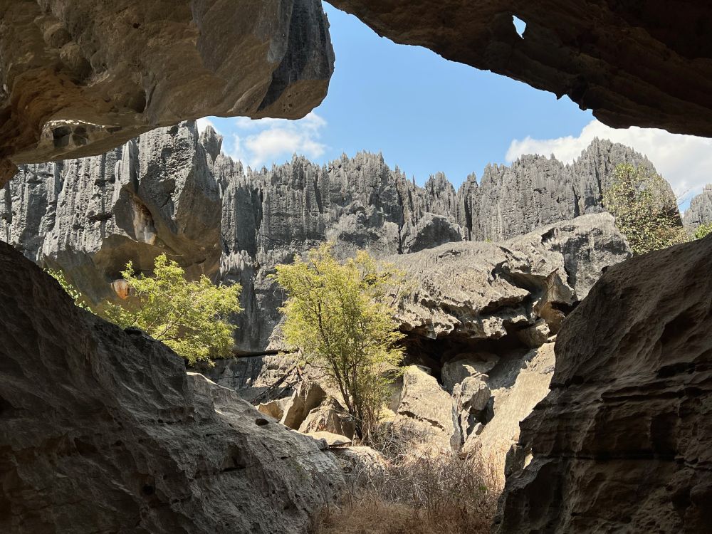 View of jagged rock formations from a cave 'window'
