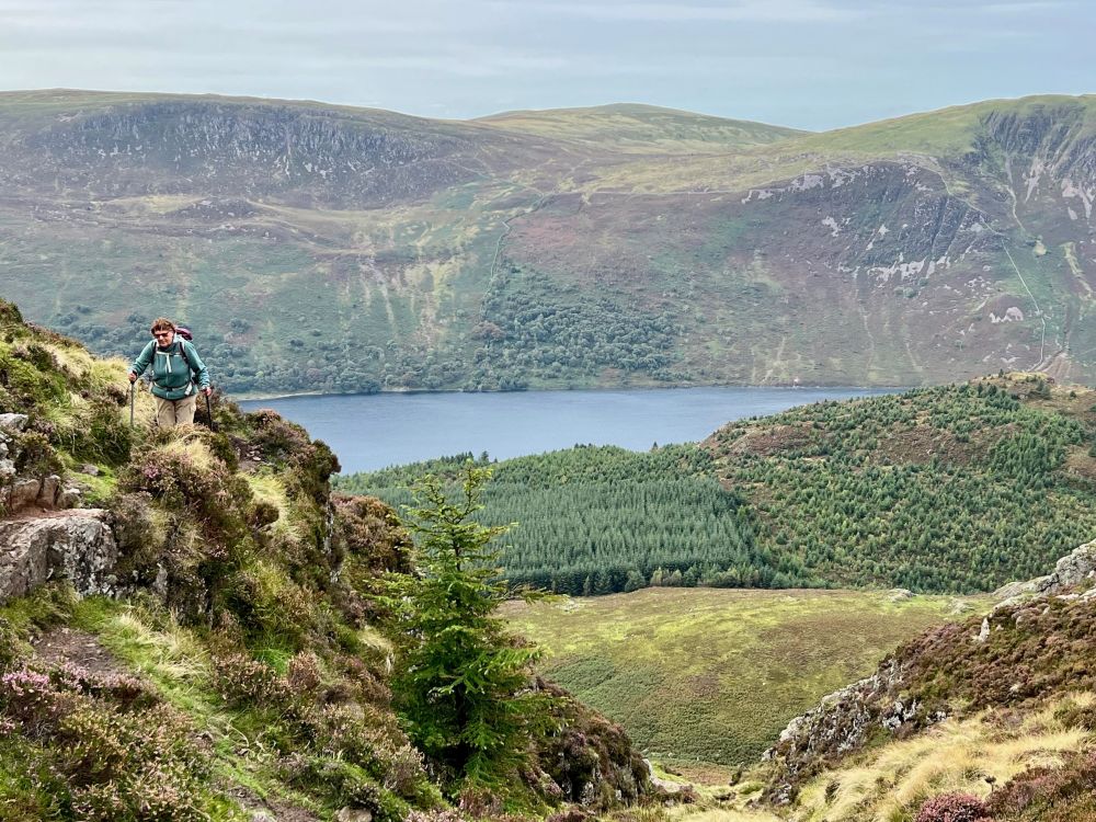 Me - in green - on a crag above Ennerdale Water, with heather-clad fells beyond