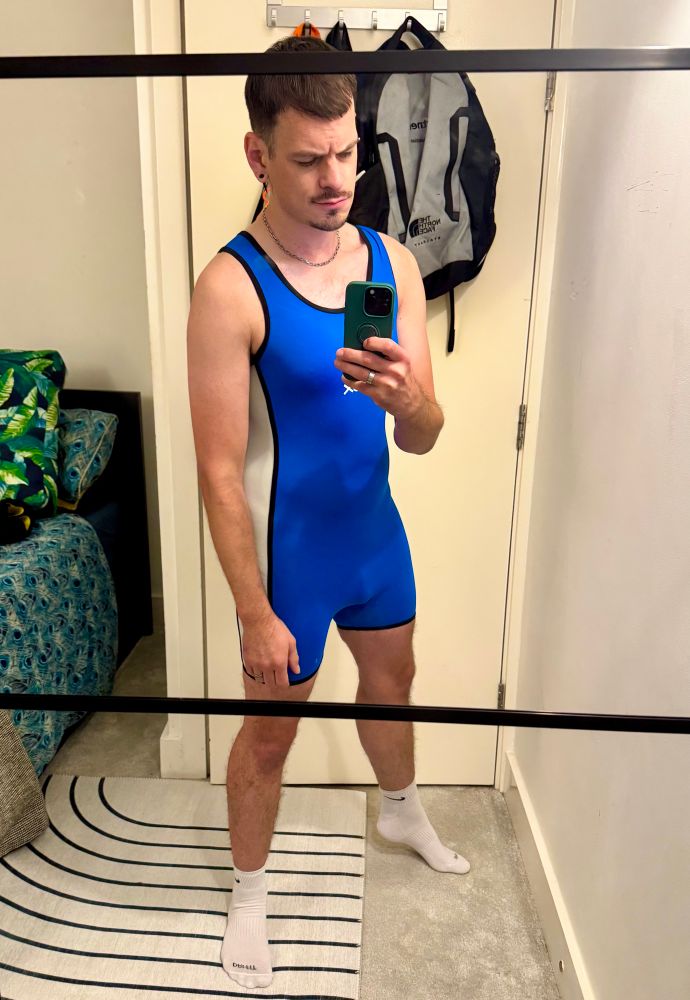 Basic white gay in a blue wrestling singlet and white socks 