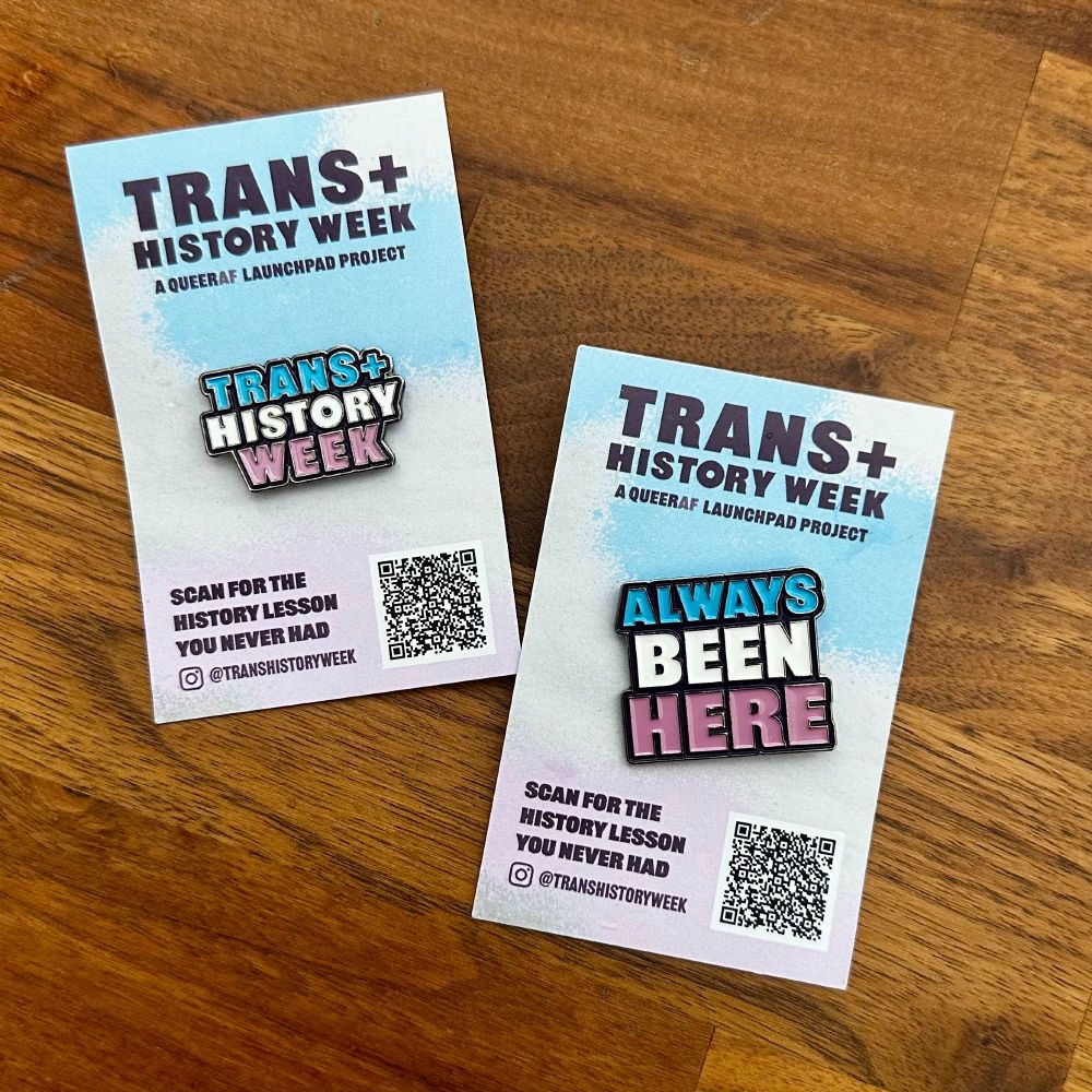 A couple of cute enamel badges from Trans+ History Week. @transhistoryweek. One says "Trans+ History Week" and the other says "ALWAYS BEEN HERE" both in trans pride colours of blue, white and pink.