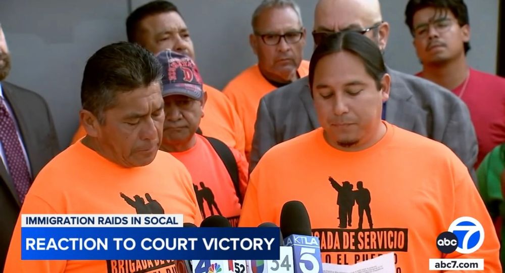 Two men in orange t-shirts in front of a microphone. The plaintiffs in a lawsuit challenging the Trump administration's immigration raids spoke publicly for the first time Monday, calling a recent appeals court ruling a major victory for Los Angeles.