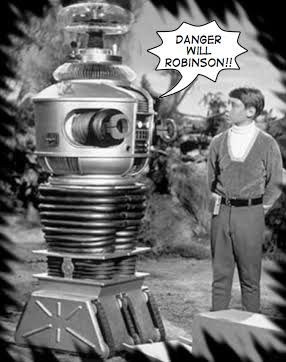 Robot on the left standing next to a futuristic boy on the right in a black and white photo. 

The text bubble says: DANGER
WILL ROBINSON!!