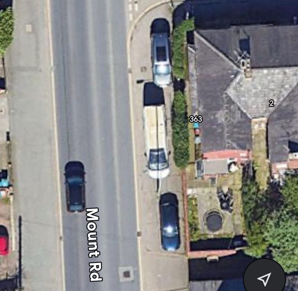 Satellite view of several vehicles blocking pavement