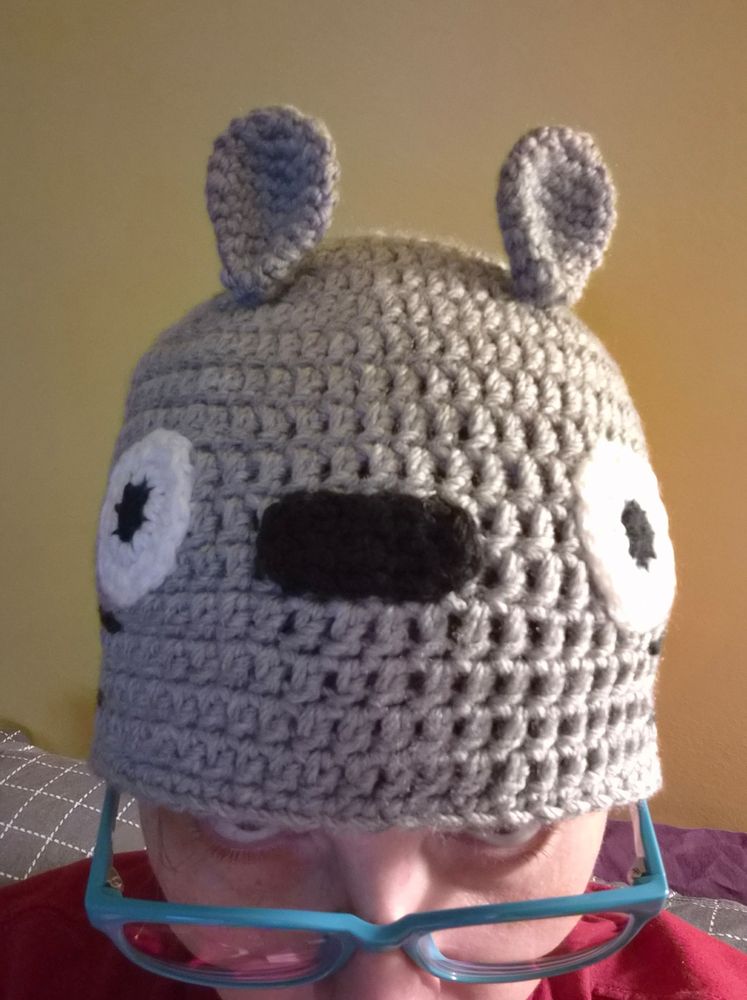 Crocheted hat in gray looking like the character Totoro from My Neighbor Totoro - on a head from the front