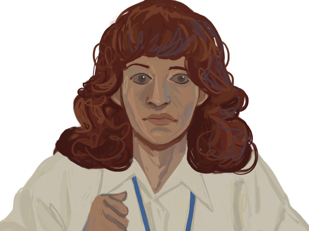 Helly R looking scared with a fist clenched. She's wearing a white blouse and a blue lanyard. Her hair is down, like Helly's always is.