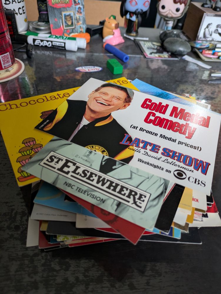 Stack of 50+ postcards. Visible are cards with the comic strip character Cathy, David Letterman, and the cast of St. Elsewhere.