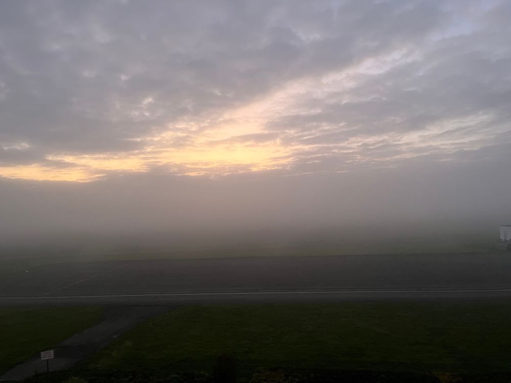 Day attempting to break through grey foggy clouds.