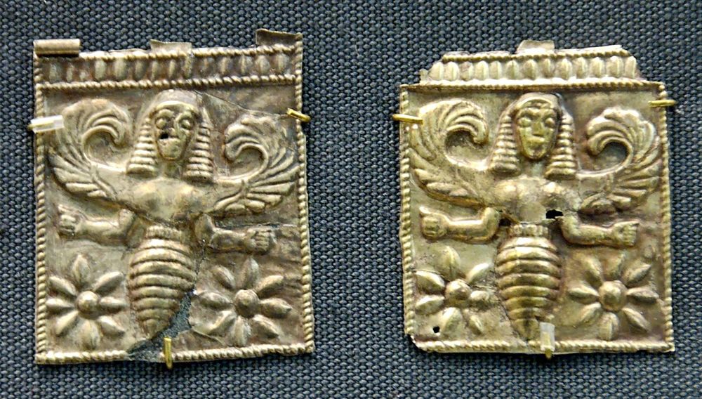 Bees on an ancient seal, looking strangely like pharaohs from the torso up with angelic wings.