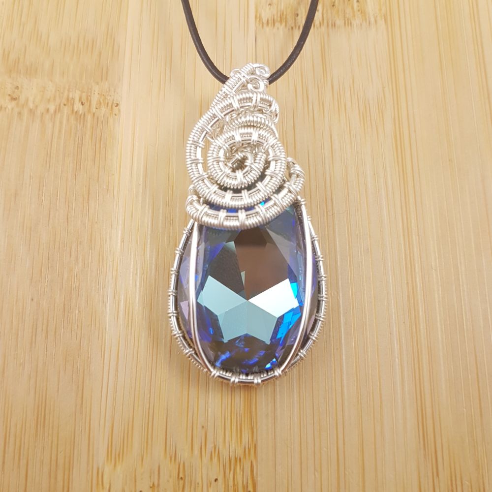 Large blue and purple Swarovksi drop pendant wrapped in spiral silver wire.