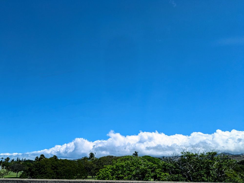 Clouds lining the horizon like the tail of a dragon