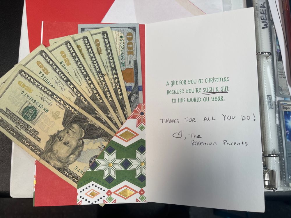 a Christmas card with $200. The text reads “a gift for you at Christmas because you’re such a gift to this world all year. Thanks for all you do! Love, the Pokémon Parents”
