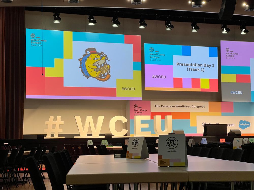 Stage of attack one with multiple projector screens and giant „#WCEU“ letters on stage