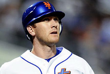 A white Canadian baseball player wearing a blue helmet with an orange NY logo stares into the abyss. 