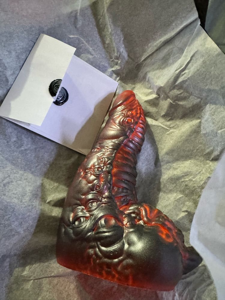 Cronenbergian dildo, it has an orange base and a graphite silver wash.