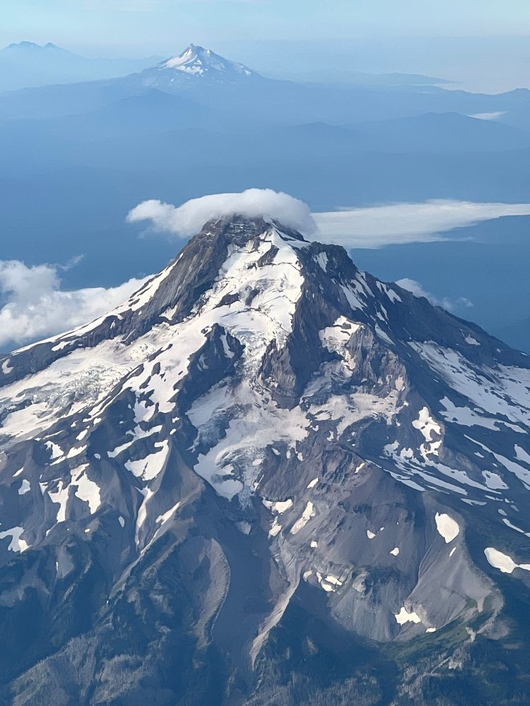 Snowy mountain peak taken from 30,000 feet in an airplane. 