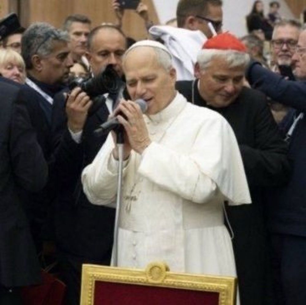 Pope holding mic as if singing