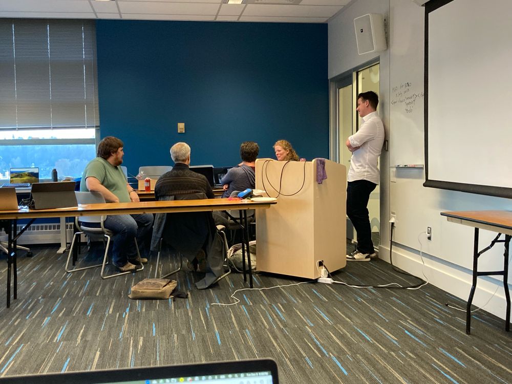 A group of determined scientists discussing data visualization with an amazing undergraduate intern in Australia