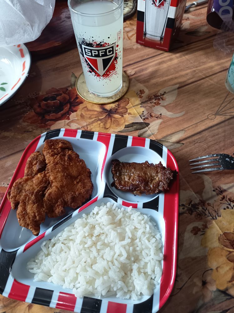 Os mesmo dois ítens da foto anterior agora com o prato com comida, arroz, frango empanado e um pequeno file de carne