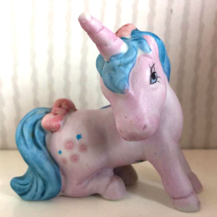 Buttons is a unicorn mare first introduced in my little pony, generation one, back during the early 1980's. she has a pastel purple coat and light blue hair with matching blue eyes. while not present on her figurine, she has reddish-pink streaks in her mane and tail in the generation one animations, or light purple streaks on her toy. she wears a bow on her tail like many of the other generation one ponies. her cutie mark is a couple of reddish-pink buttons and a few light blue stars