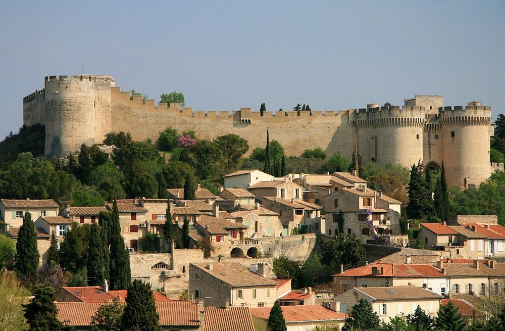 The battlements of a big castle overlook the Provencal rooftops of Villeneuve. 