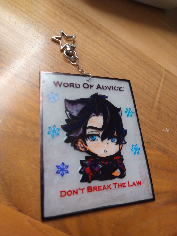 Wriothesley from genshin impact as a chibi crossing his arms. It says "Word Of Advice: Don't Break The Law. But this time it has a star Keychain ring. 