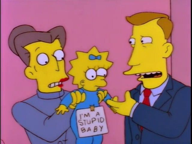 A cartoon baby being held up with a sign that says I'm a stupid baby on her
