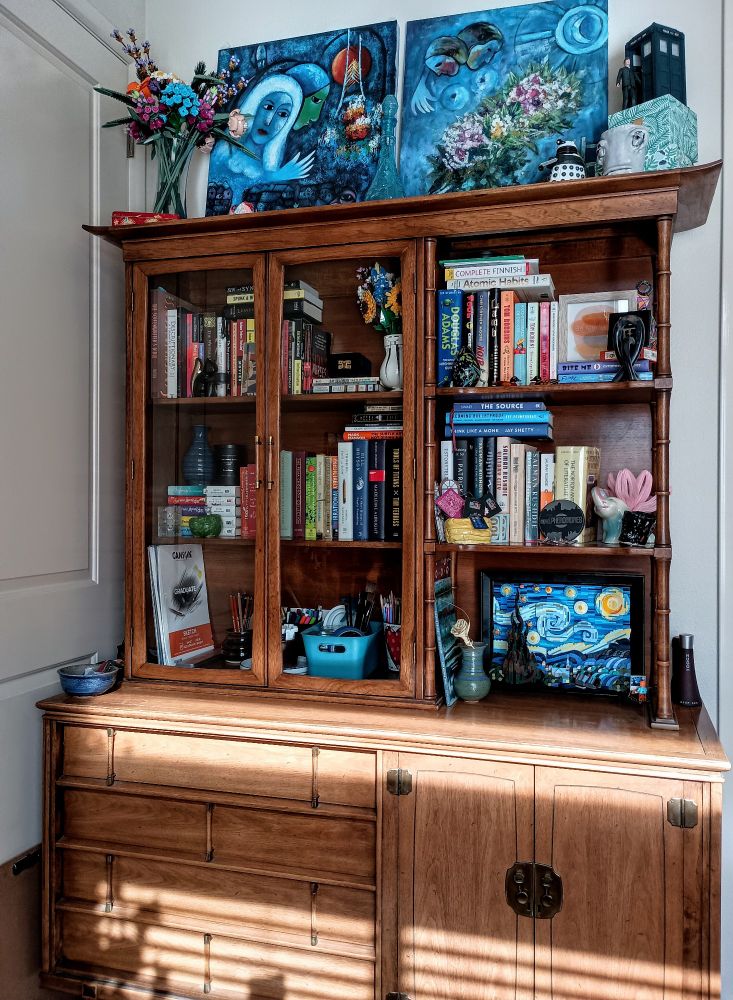 China cabinet filled with books. 